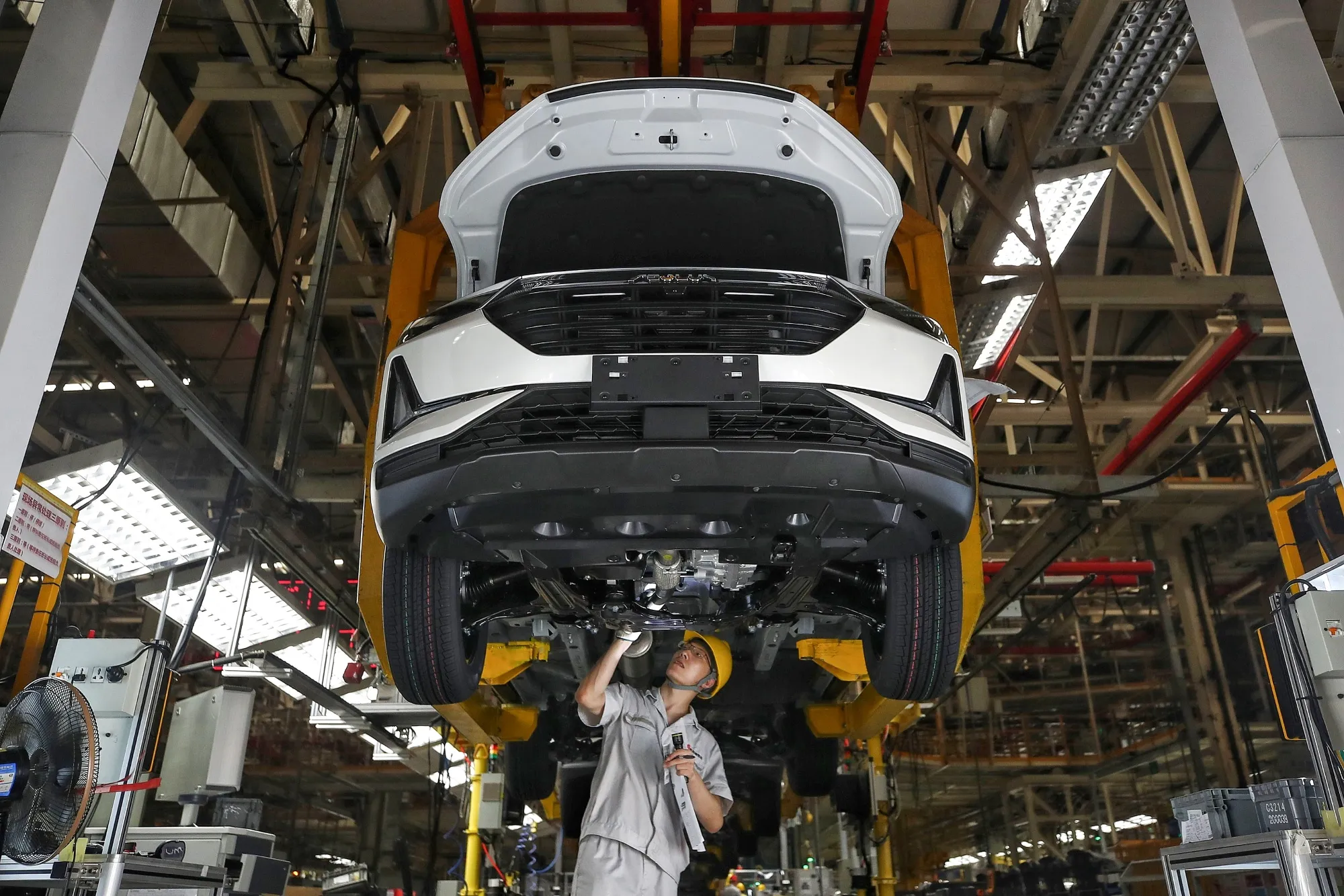 An employee works on the car assembly line at a Dongfeng factory in Wuhan, China.