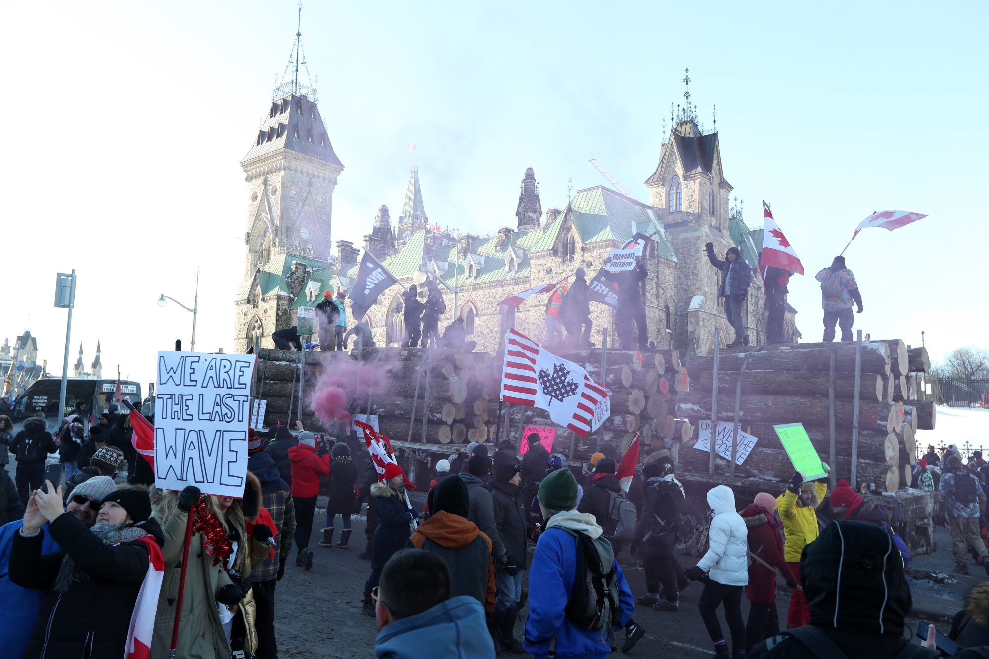 Demonstrators stand on a logging truck outside the parliament buildings in Ottawa on Jan. 29, 2022.