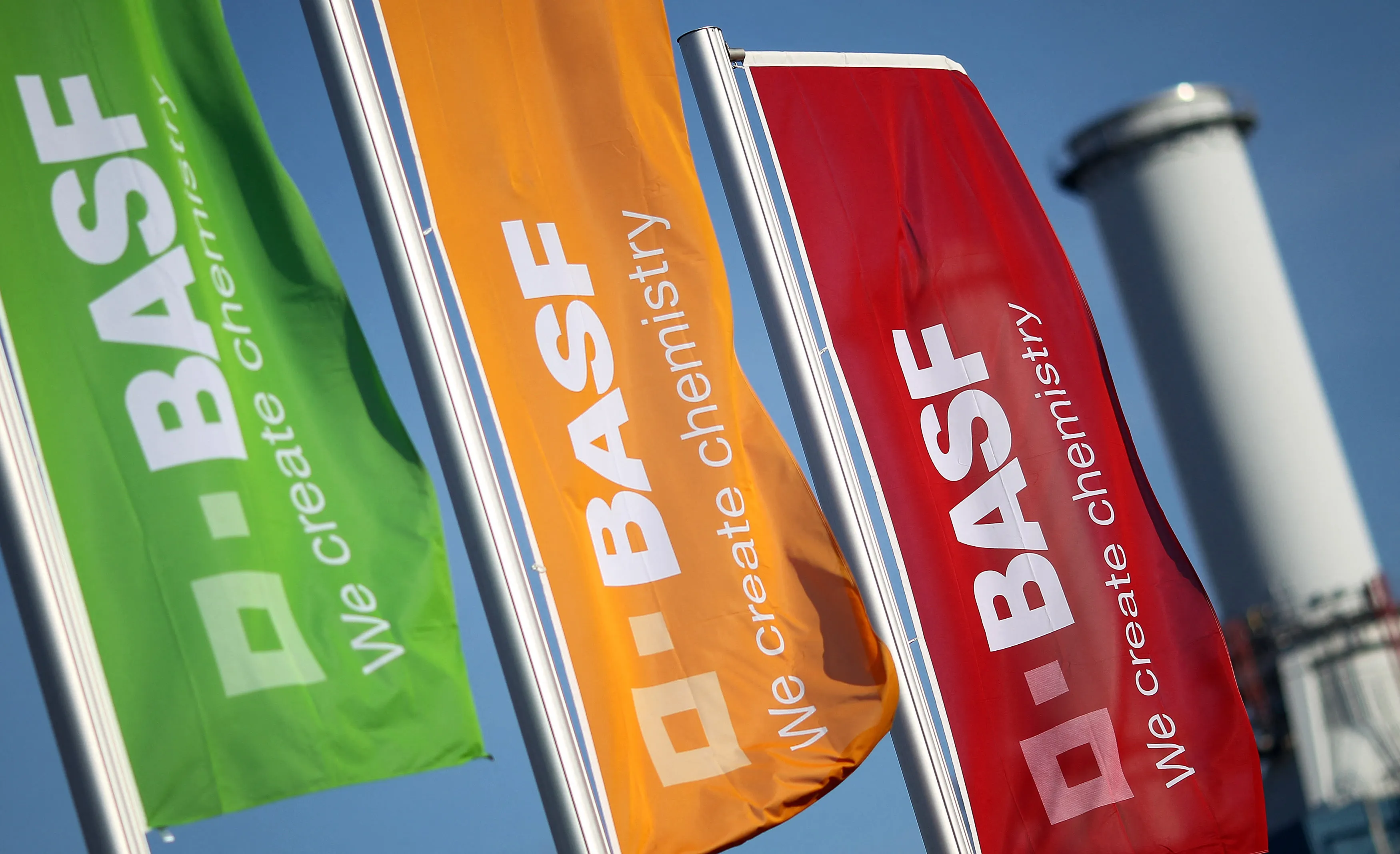 The logo of German chemical giant BASF is seen on flags fluttering in front of the company's headquarters in Ludwigshafen, Germany.