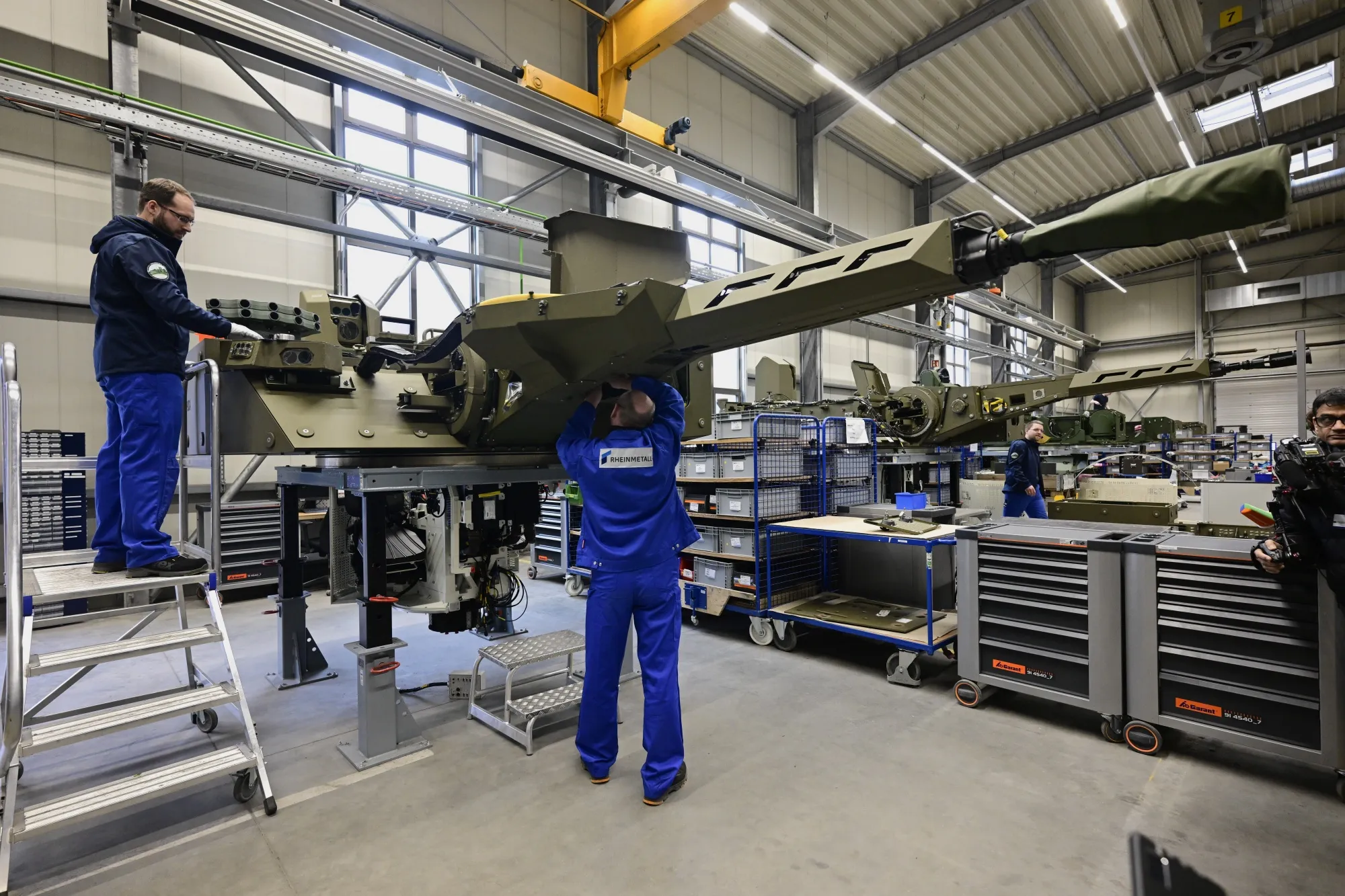Employees work at a production line at a&nbsp;Rheinmetall factory&nbsp;in Unterluess, Germany.