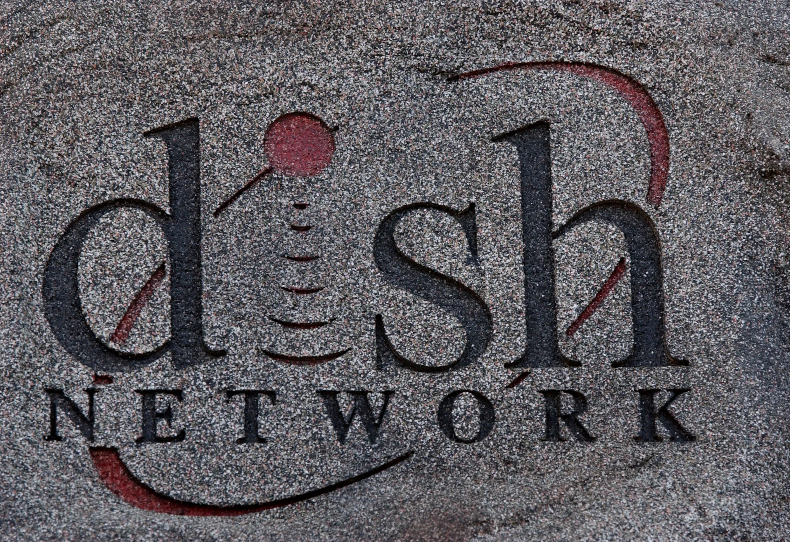 The logo oif the Dish satellite-television network is engraved on a decorative stone outside EchoStar headquarters