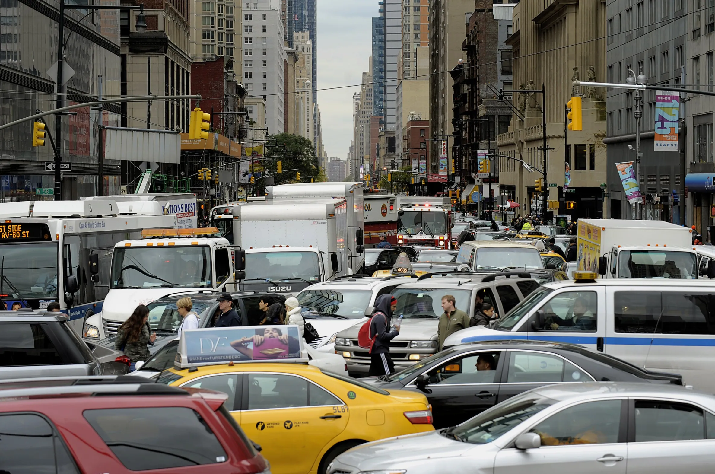 Pedestrians pass through congested traffic at Columbus Circle in New York.