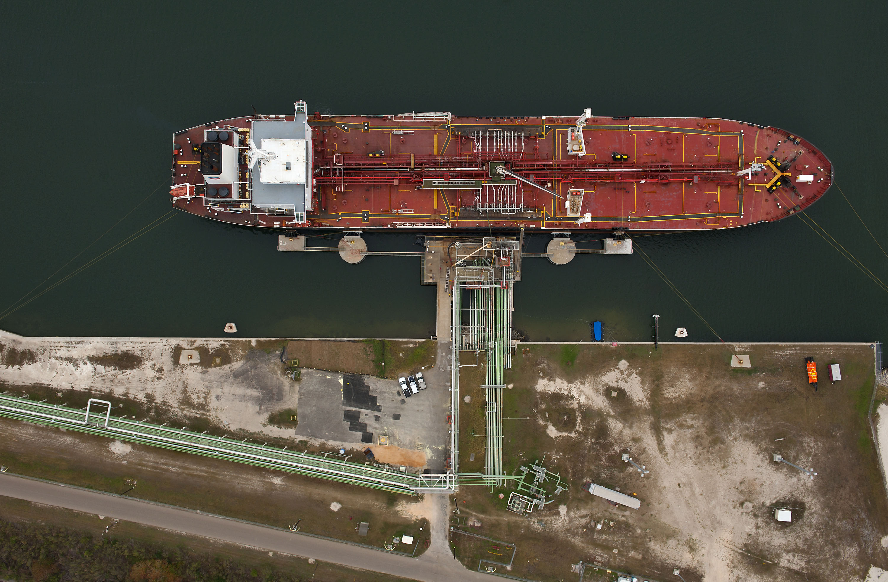 The Chevron Corp. tanker California Voyager loads oil products at the Port of Corpus Christi in Corpus Christi, Texas, U.S., as seen in this aerial photo taken on Monday, Dec. 27, 2010. U.S. crude oil inventories probably fell last week as refiners along the Gulf Coast lowered supplies to reduce their assets at the end of the year, a Bloomberg News survey showed. Photographer: Eddie Seal/Bloomberg