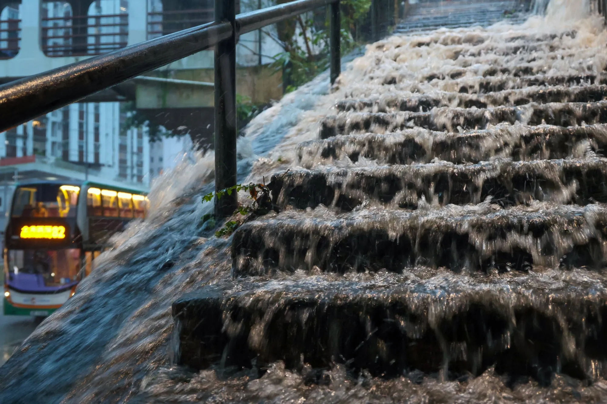 Rainwater rushes down a flight of stairs in Hong Kong on Aug. 5.