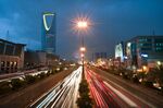 Vehicle light trails pass the Kingdom Tower on King Fahad Road in Riyadh, Saudi Arabia.
