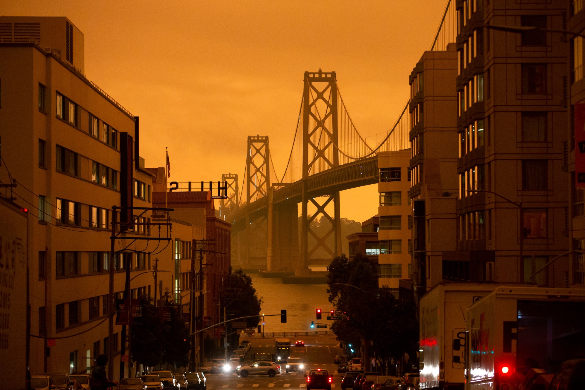 Wildfire smoke covers downtown San Francisco and the Bay Bridge on Sept. 9, 2020, known locally as the “Day of the Orange Sky.”&nbsp;