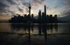 The sun rises behind the skyline of Pudong's Lujiazui Financial District in Shanghai.