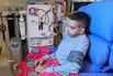 Amit Sanchadev, whose only functioning kidney failed in 2019, plugs himself into his dialysis machine at home.