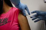 A health worker vaccinates a participant during clinical trials&nbsp;in Florida.