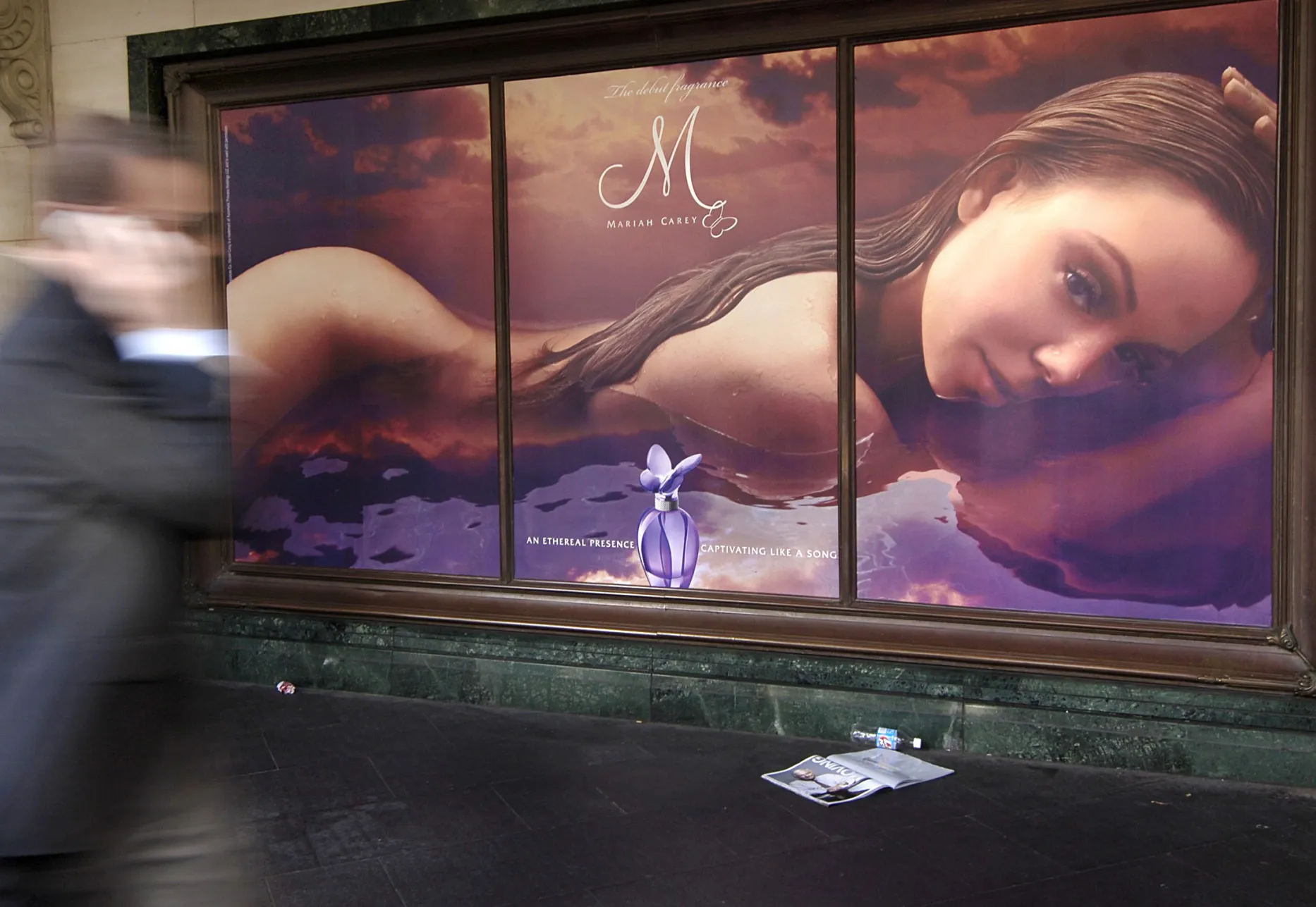 A man walks past an advertisement for perfume in Sydney, Australia.
