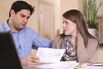 Young couple working out family finances together at home.