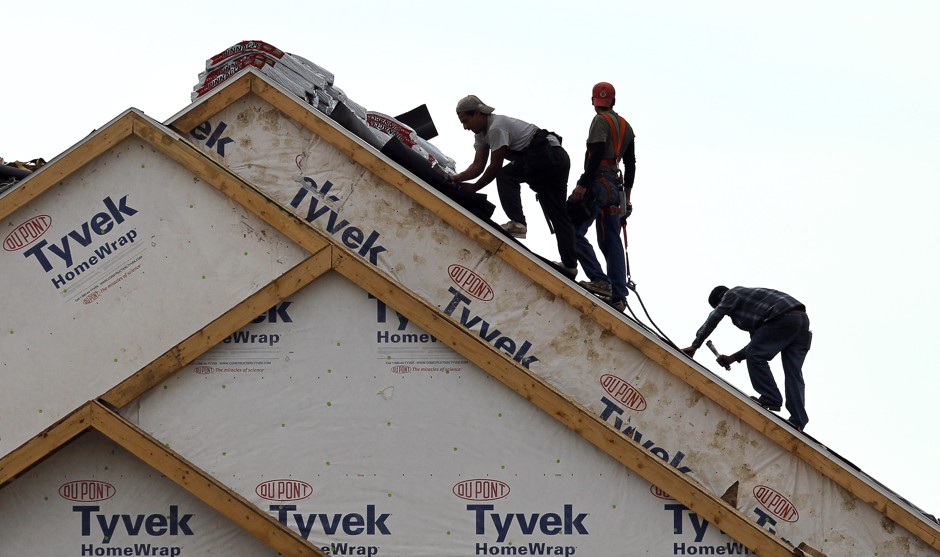 Construction on a home in Des Moines, where new zoning rules that mandate building materials, garages, and other features could increase construction costs.