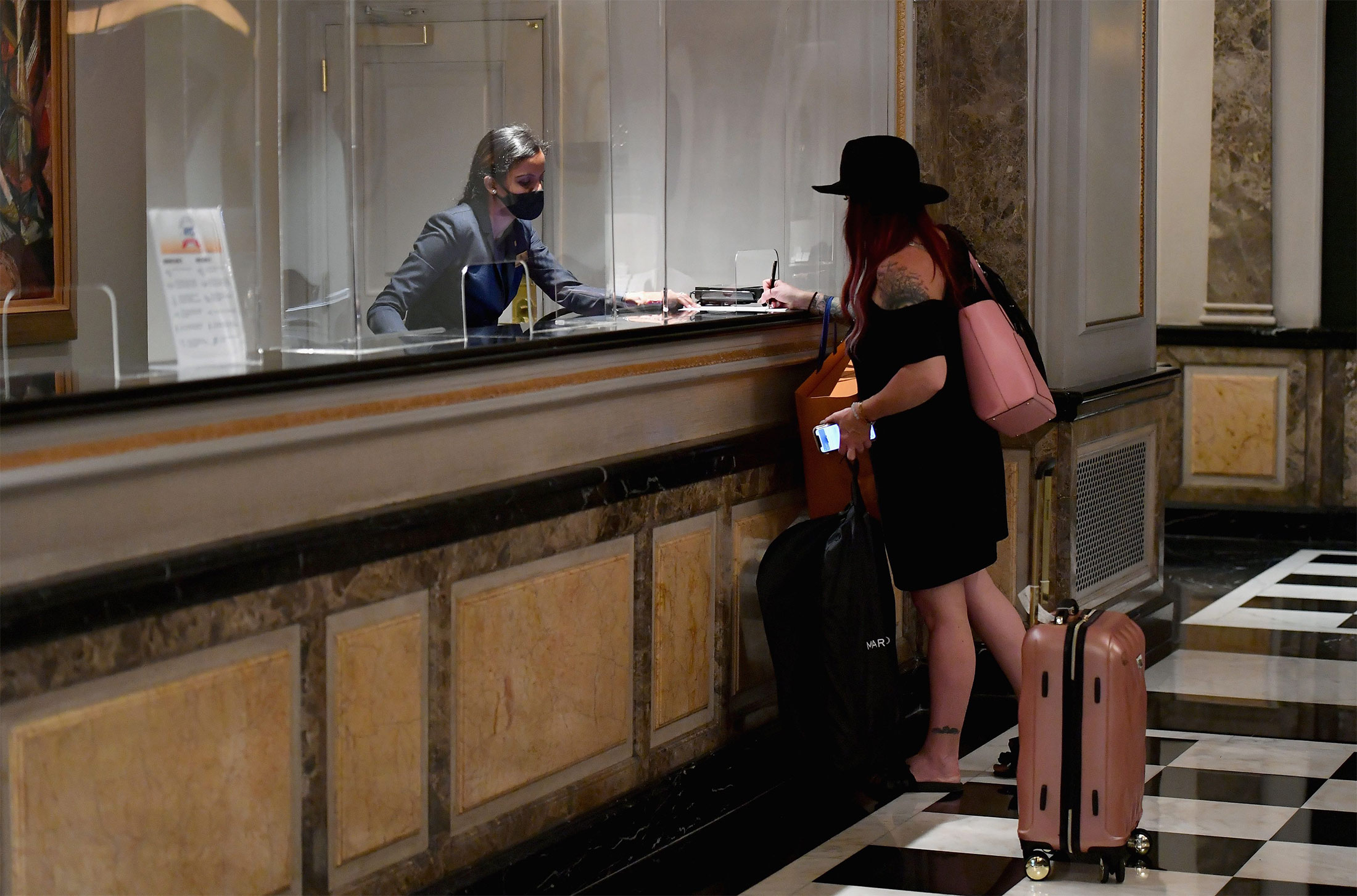 A worker helps a guest at a&nbsp;hotel in&nbsp;New York in September 2020.