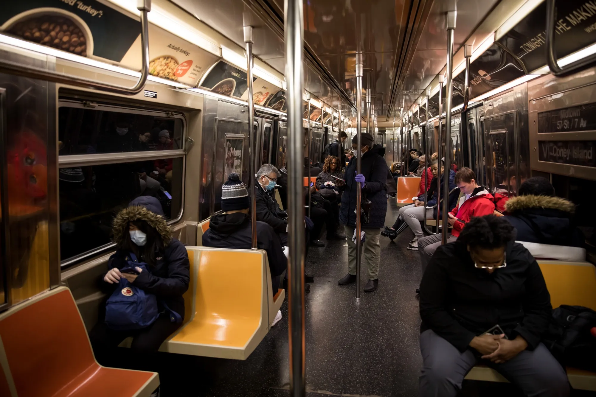 Subway riders wear protective masks during the morning commute in New York.