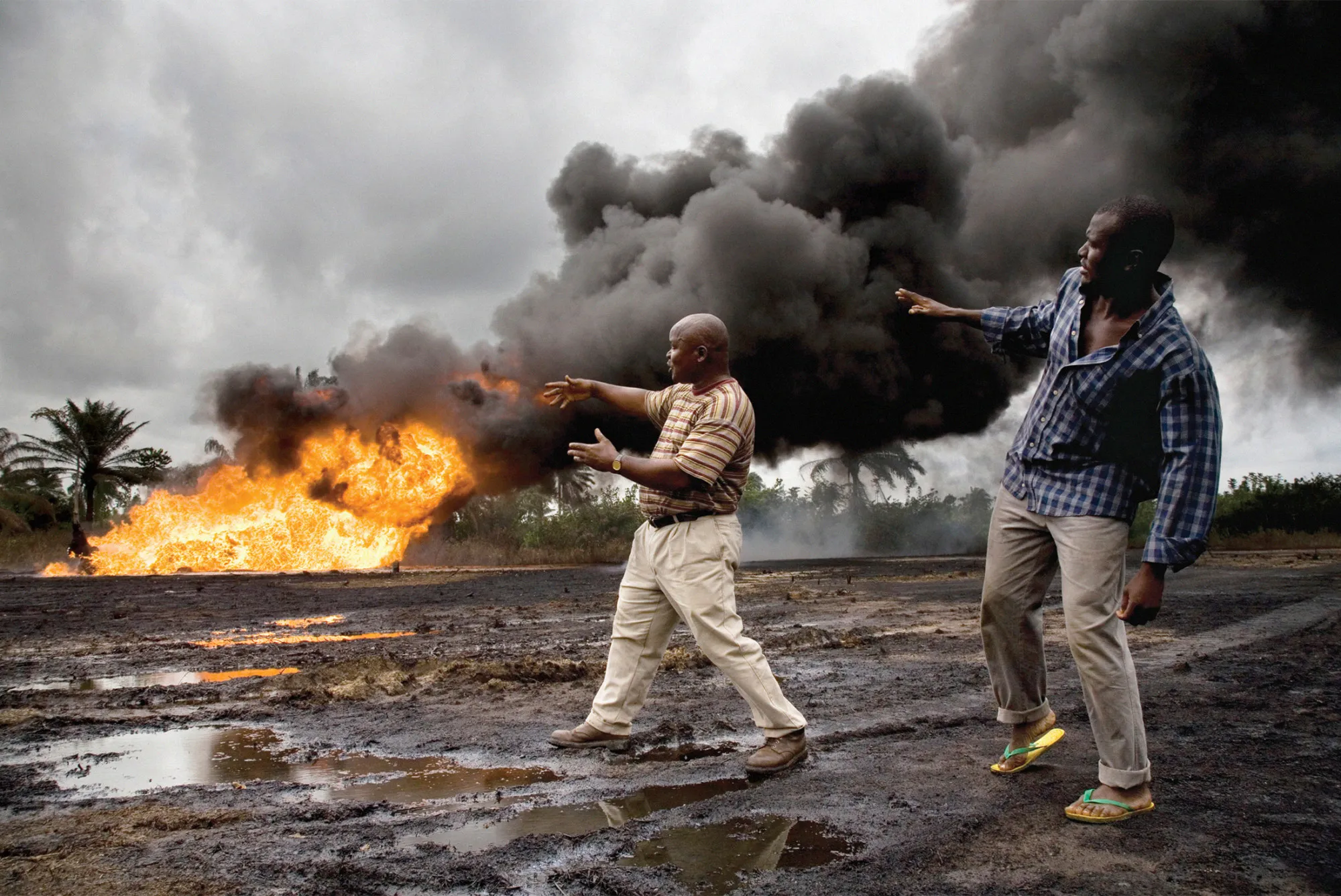 A leaking, out-of-service Shell oil well head catches fire in Nigeria in 2006.