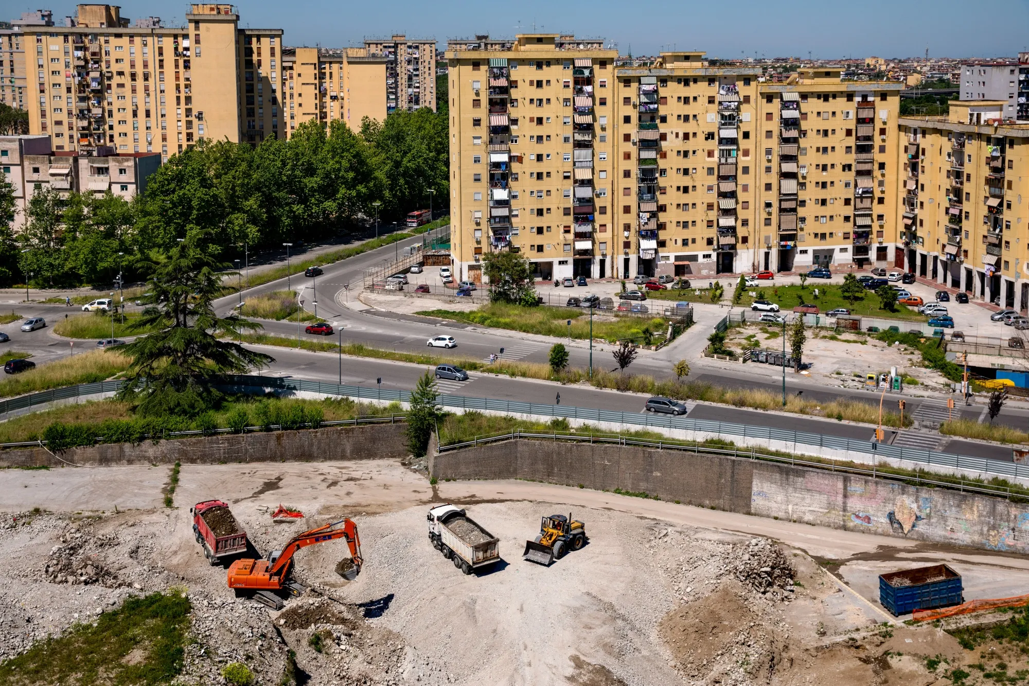 Workers remove debris from a housing estate demolished last year in Naples.