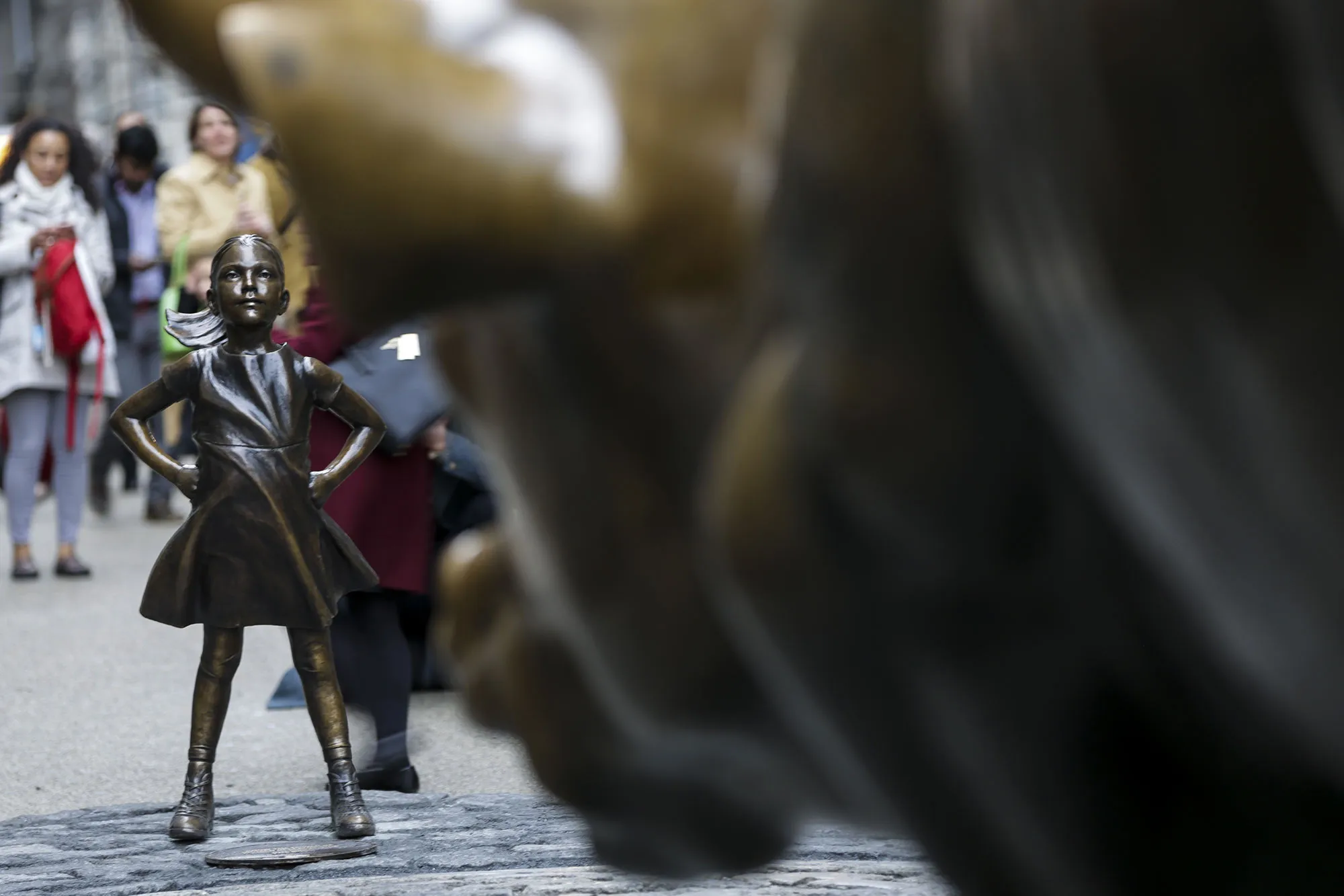 'Fearless Girl' stands facing the Charging Bull sculpture in the Financial District of New York, on March 8, 2017.
