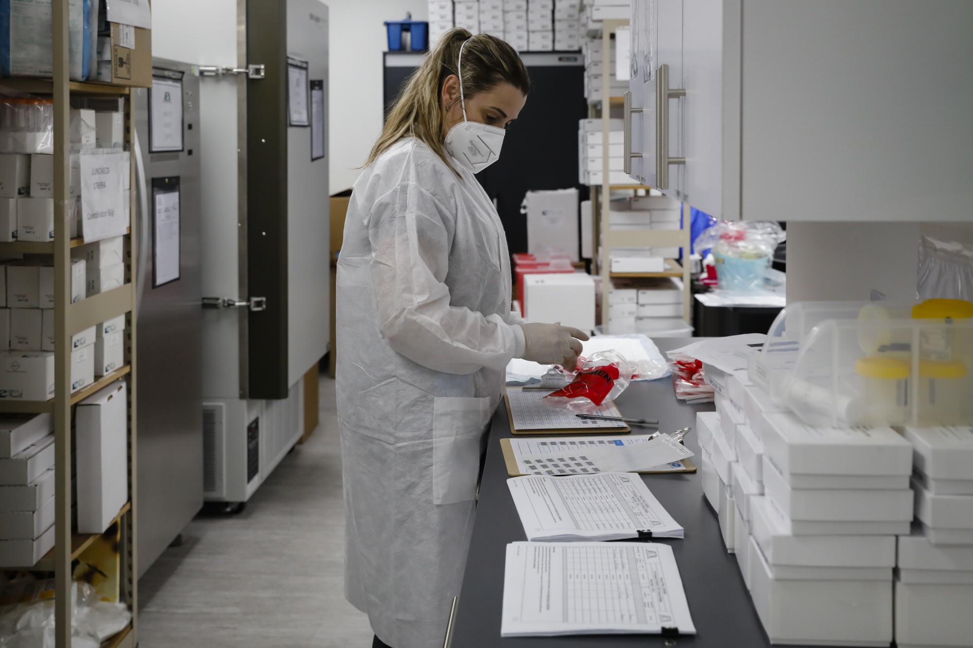 A healthcare worker wearing a protective mask works in a laboratory during clinical trials for a Covid-19 vaccine at the Research Centers of America in Hollywood, Florida, U.S., on Wednesday, September 9, 2020. 