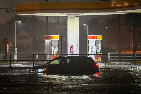 A stranded vehicle on a flooded street in Brandon, near Tampa on Oct. 9.