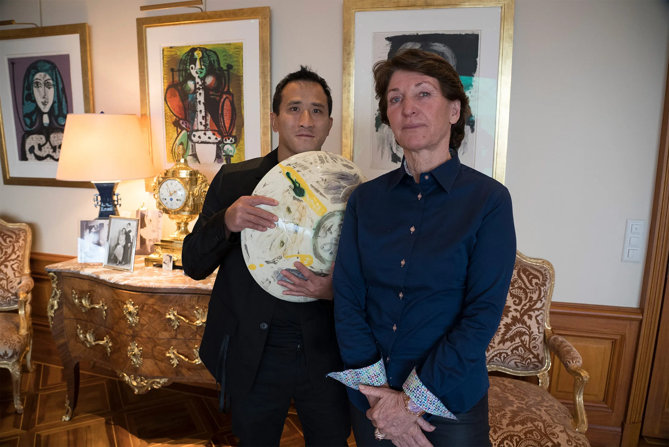 Marina Picasso, right, granddaughter of artist Pablo Picasso, and her son Florian Picasso pose with a ceramic art-work of Pablo Picasso in Cologny near Geneva, Switzerland, Jan. 25, 2022.