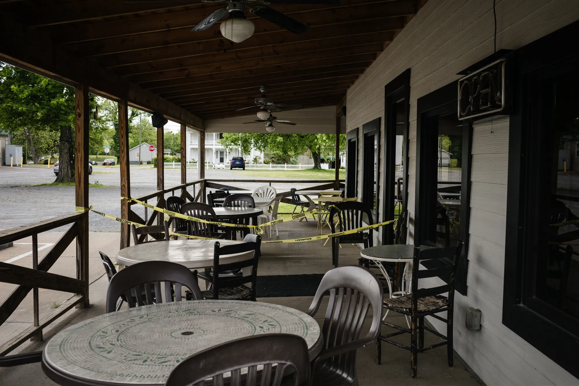 Caution tape surrounds outside seating at a temporarily closed barbecue restaurant in Cartersville, Georgia.