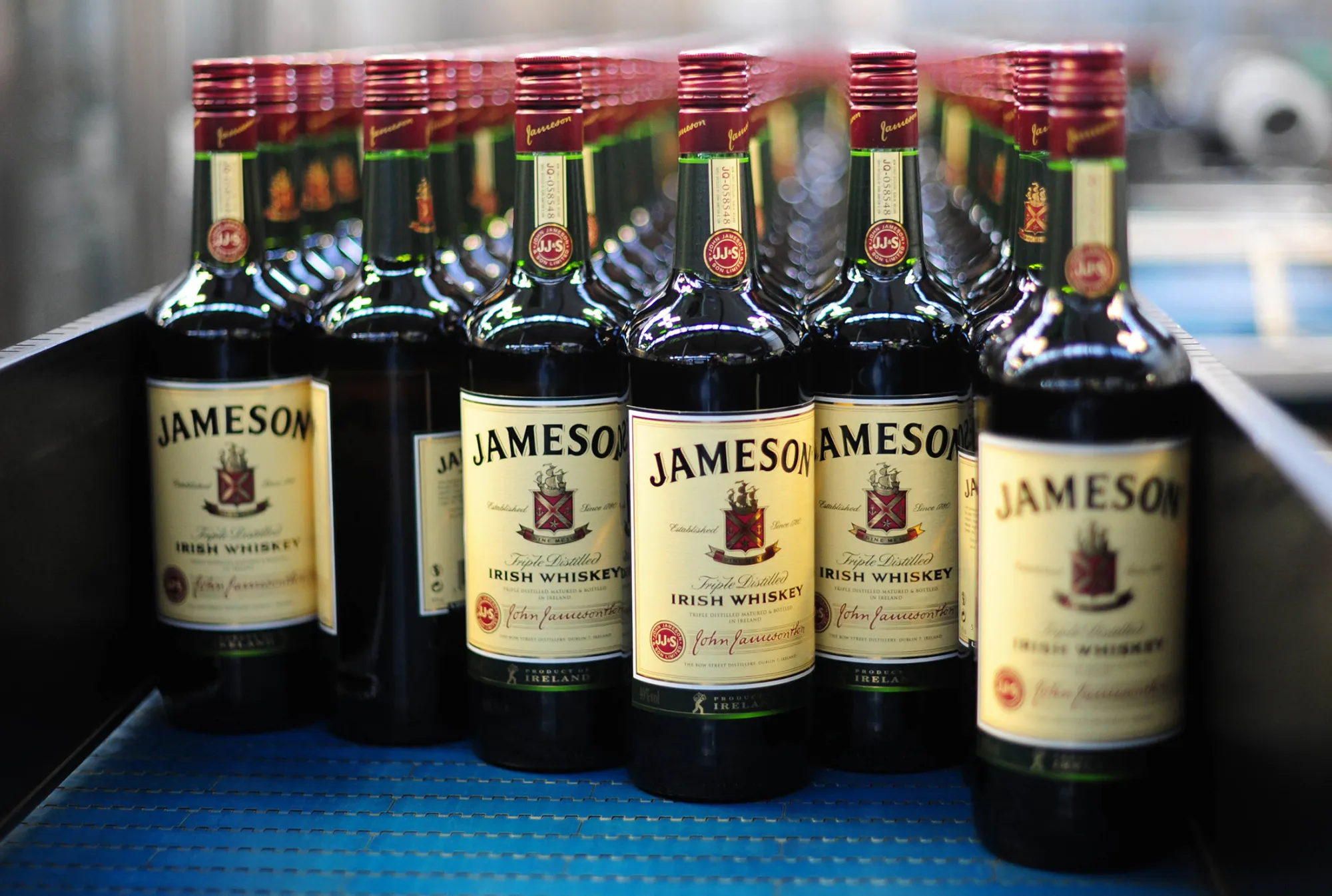 Bottles of Jameson whiskey, produced by Irish Distillers Ltd., are seen as they pass along the production line at the Pernod-Ricard SA bottling plant in Dublin, Ireland, on Monday, Jan. 23, 2012. Pernod-Ricard SA sold $2.5 billion of debt, its second sale in three months, as the maker of Chivas Regal whisky takes advantage of the investment-grade ratings gained last year from the two biggest credit graders. Photograph: Aidan Crawley/Bloomberg
