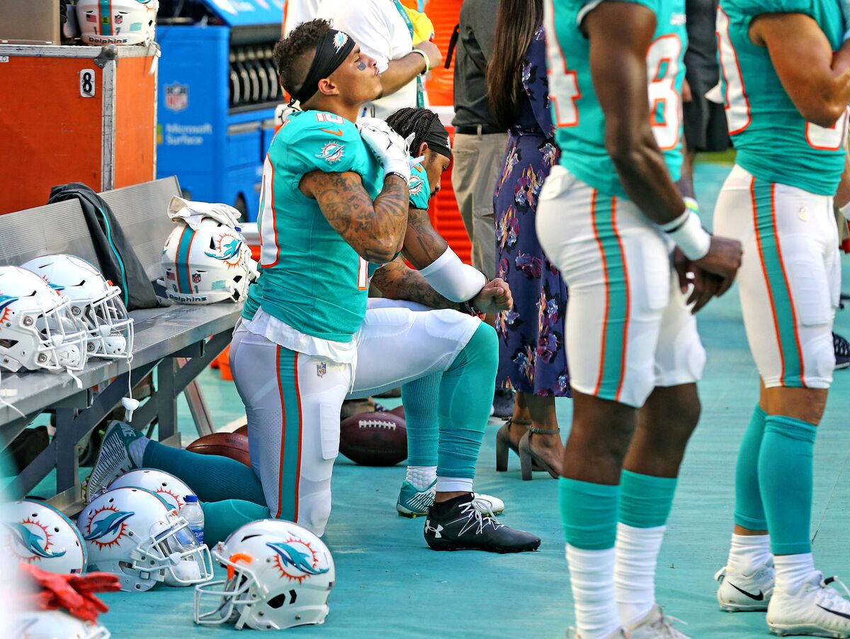 Fans burn Dolphins jerseys to protest anthem kneeling