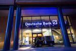 A road cleaning machine drives past the exterior of a Deutsche Bank AG bank branch in Berlin, Germany, on Wednesday, Sept. 28, 2016.
