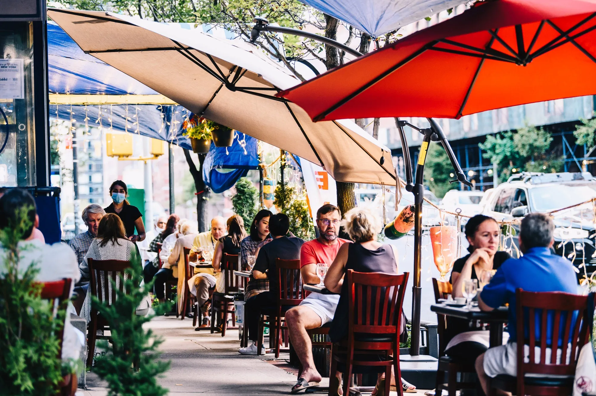 People sit in an outside area of a restaurant in New York, U.S., on Wednesday, July 15.