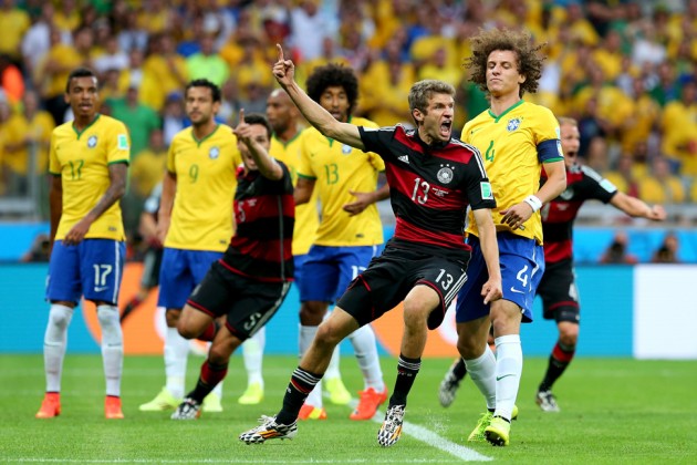 Thomas Müller of Germany celebrates scoring his team's first goal during their 2014 FIFA World Cup Semi Final match against Brazil.
