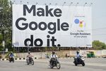 Indian commuters pass an advertisement for Google in Bangalore.