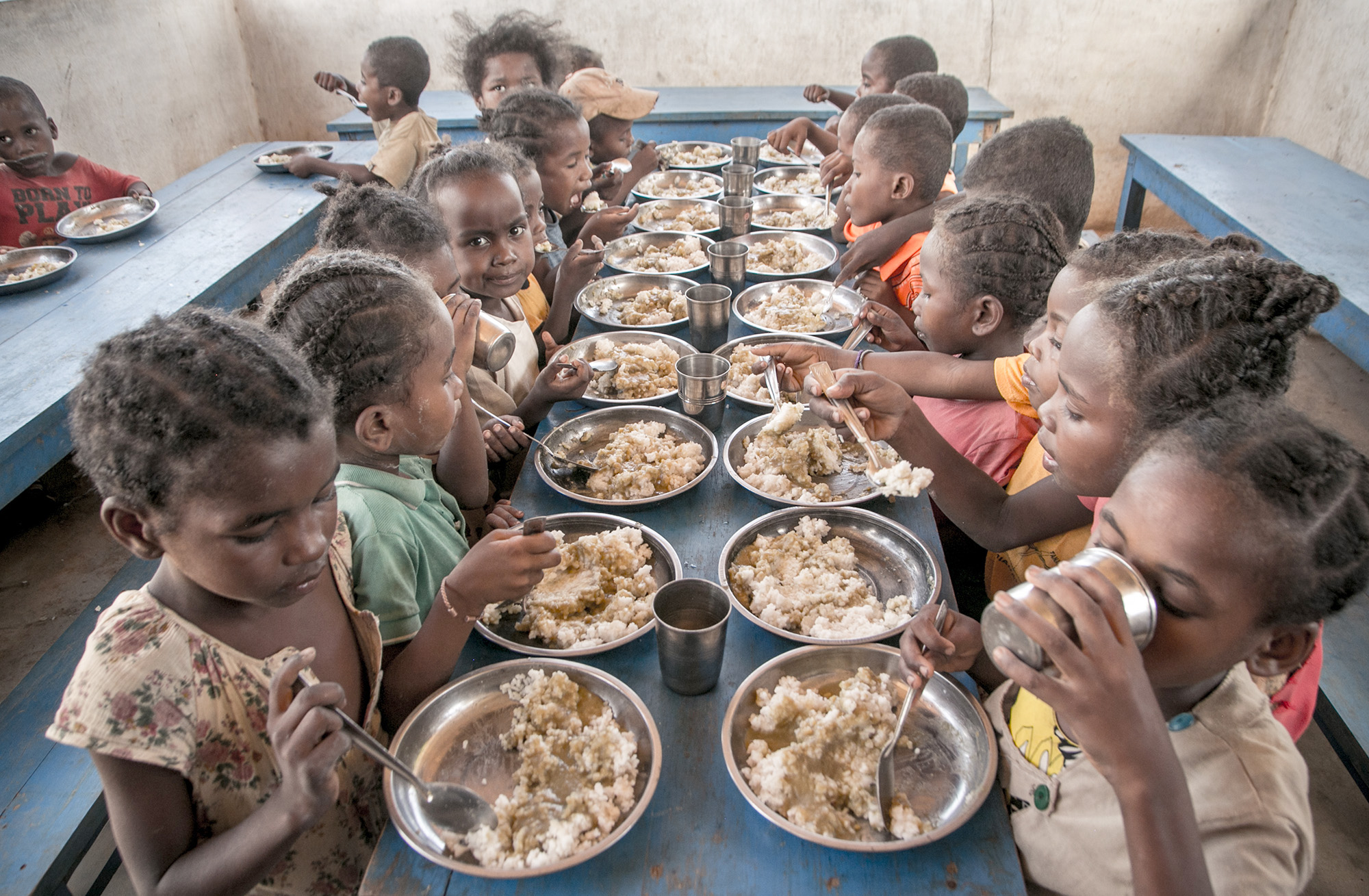 Schoolchildren eat lunch, offered by the World Food Programme's Under-nutrition Prevention Programme, in the Amboasary-South district of southern Madagascar.