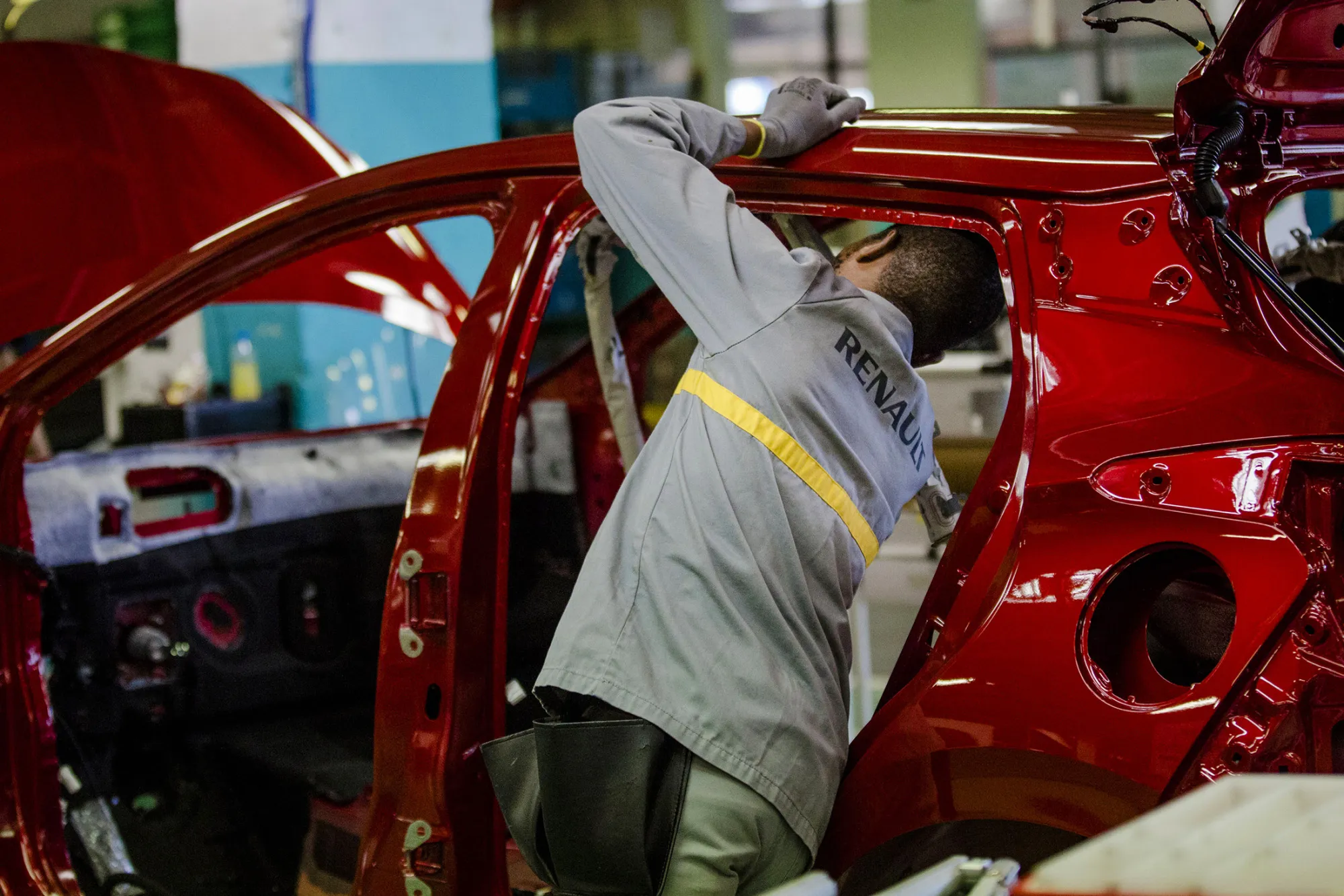 An employee carries out final inspections on the body shell of a freshly painted Nissan Micra automobile inside the Renault SA factory in Flins, France, on Thursday, Feb. 23, 2017. Carlos Ghosn, one of the auto industry's most celebrated turnaround artists, is relinquishing his CEO role at Nissan Motor Co. and turning over day-to-day control to Hiroto Saikawa as he focuses on strengthening the carmaker's alliance with Renault and Mitsubishi Motors Corp.
