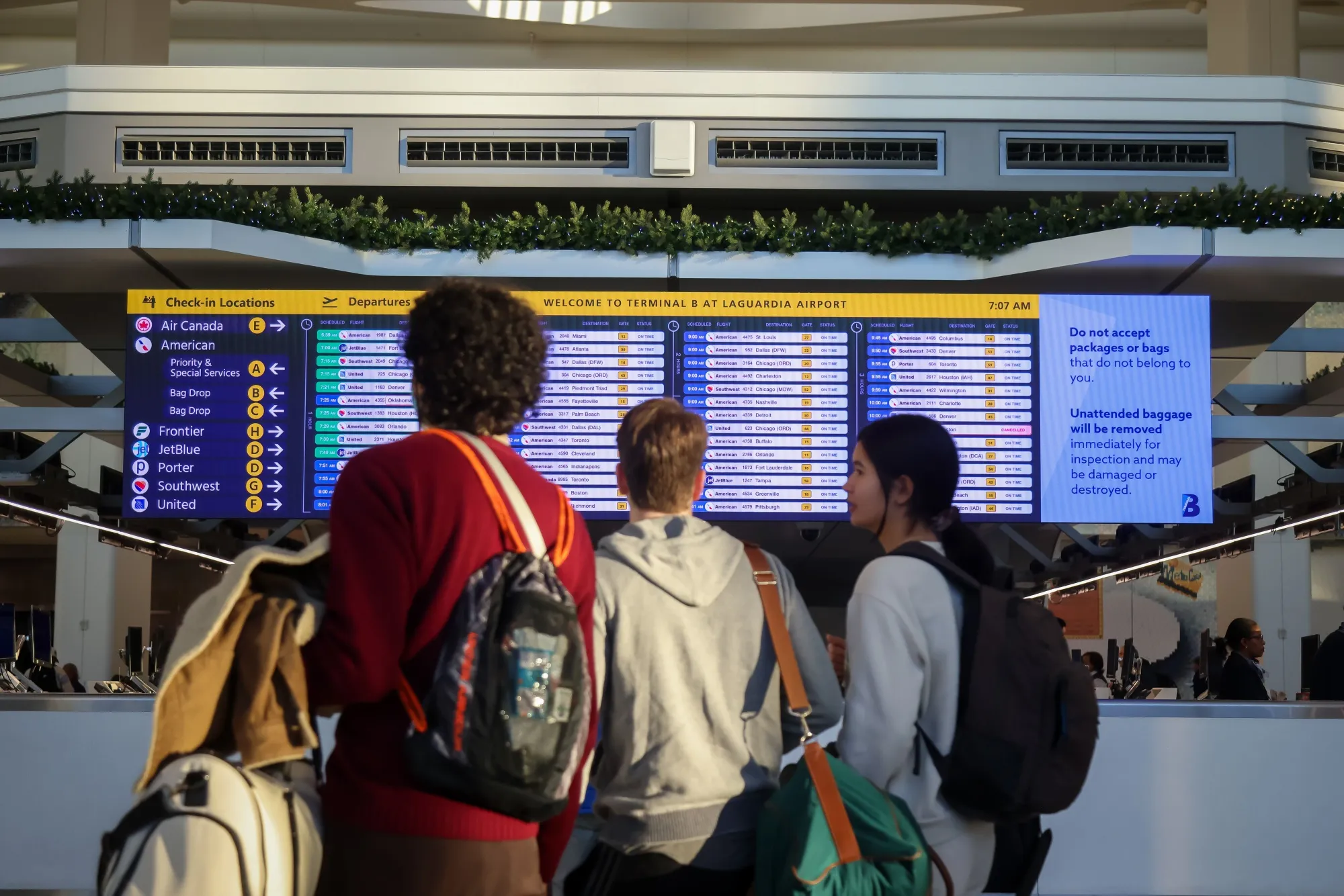 Travelers look at a flight information board in Terminal B at LaGuardia Airport (LGA) in the Queens borough of New York&nbsp;on&nbsp;Nov. 7.