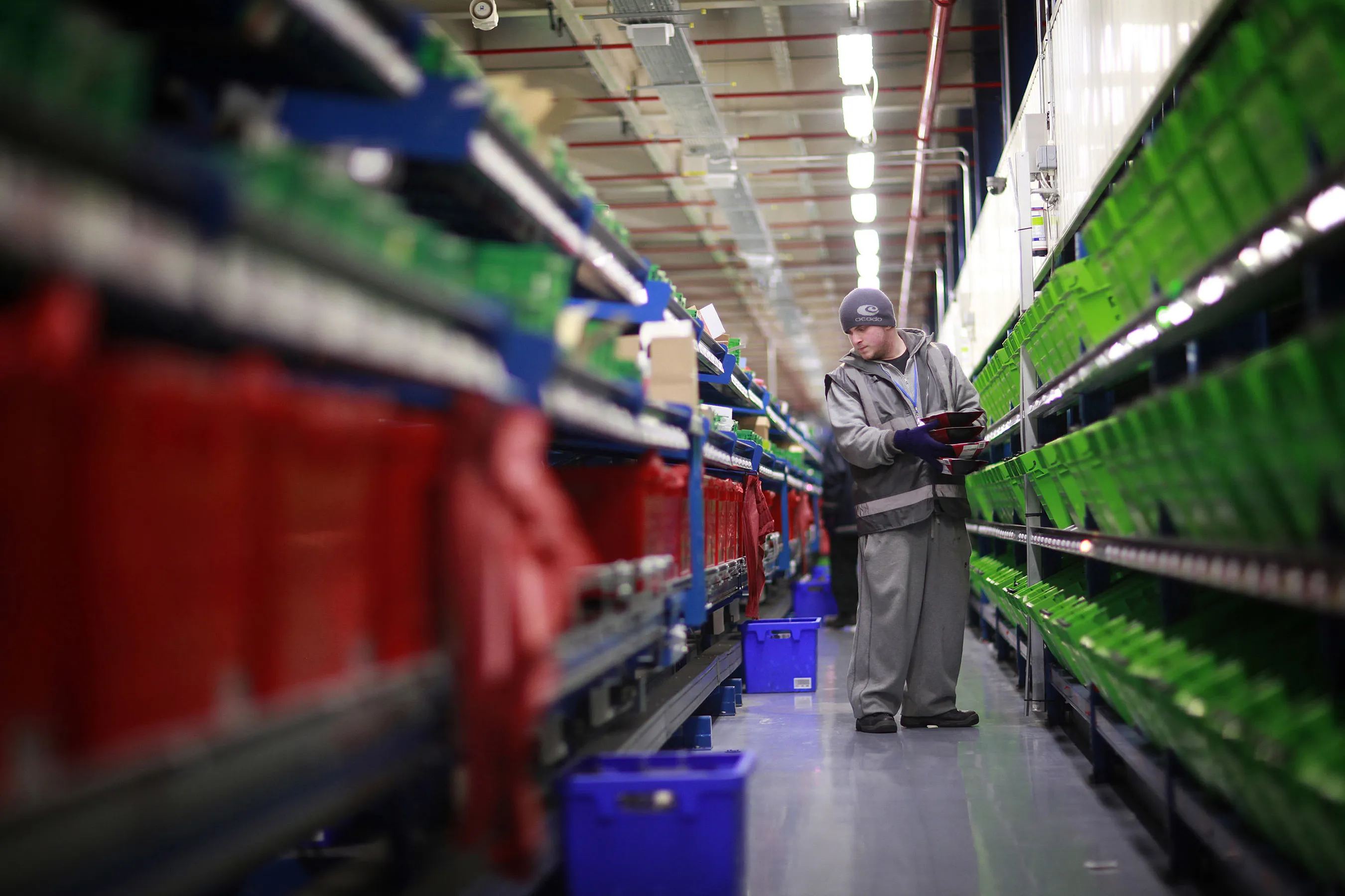 An employee packs boxes at the Ocado Ltd. distribution center in Hatfield.
