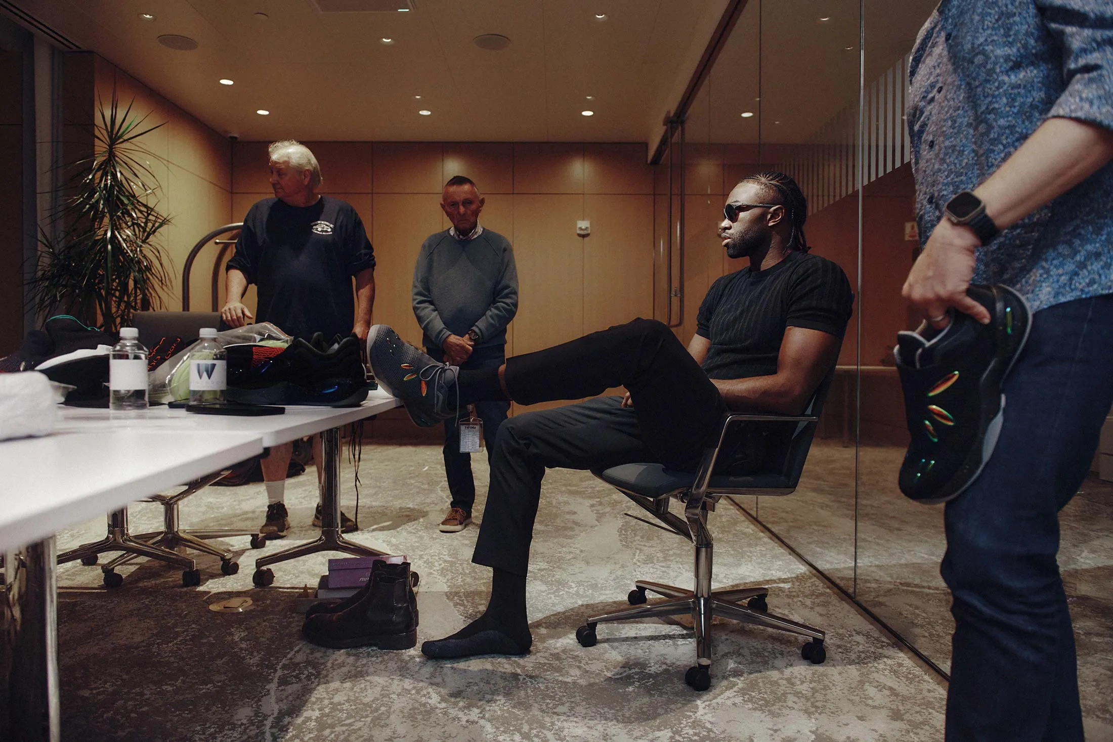 Brown, seated, talks business with the&nbsp;741 team in Boston.