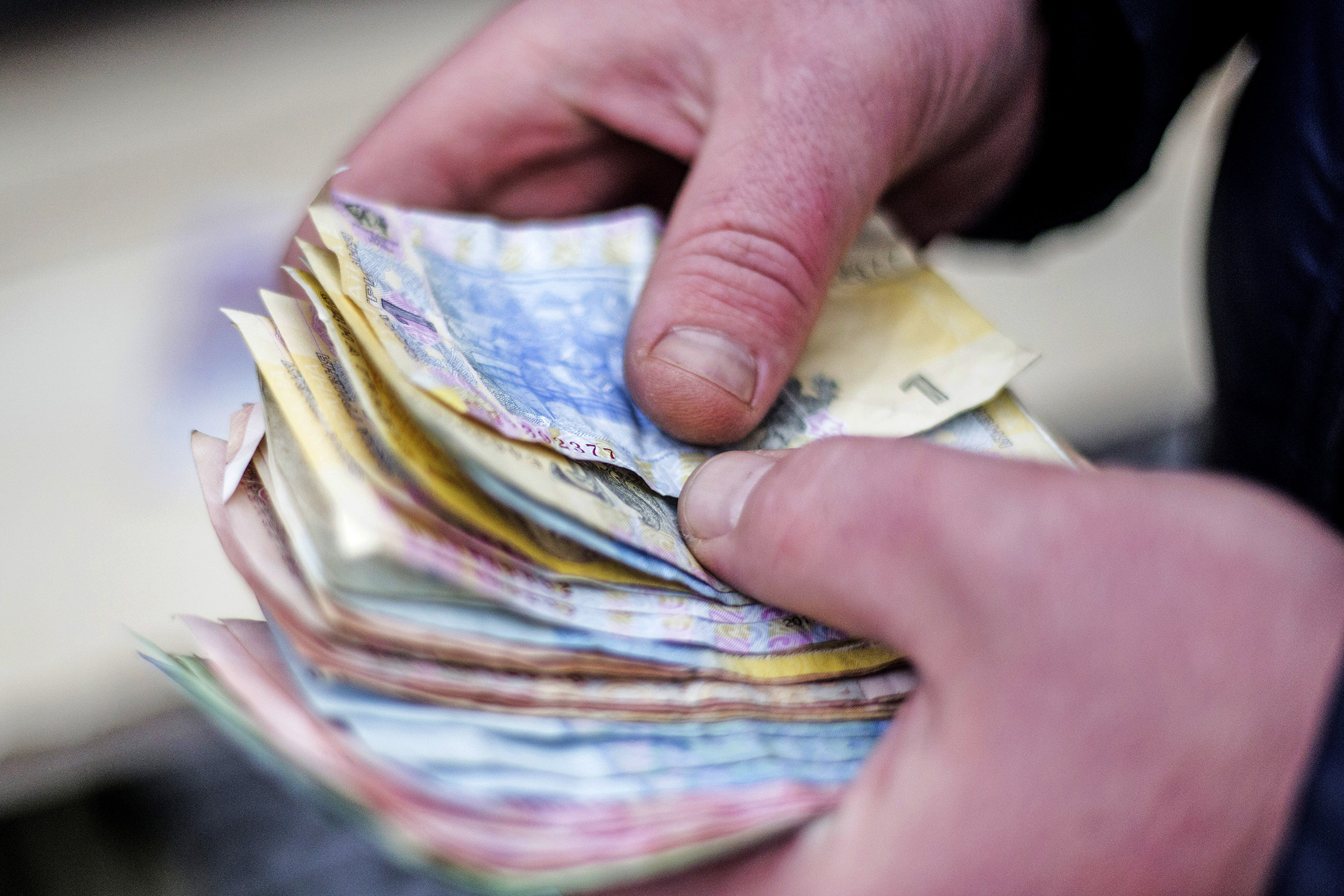 A Trader Holds Bundles of Hryvnia Banknotes
