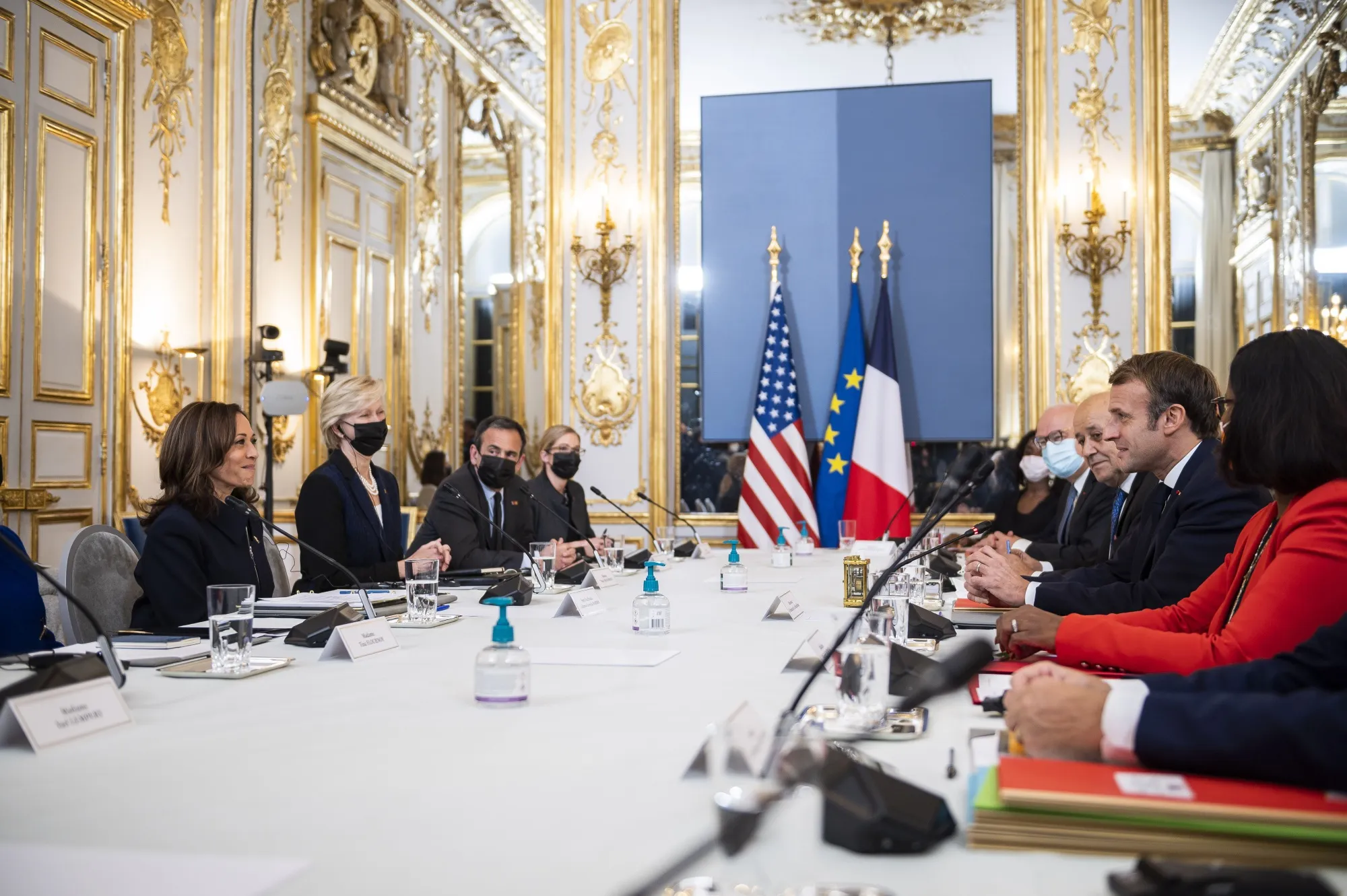 Kamala Harris, left, speaks with Emmanuel Macron, second right, in Paris, on Nov. 10.