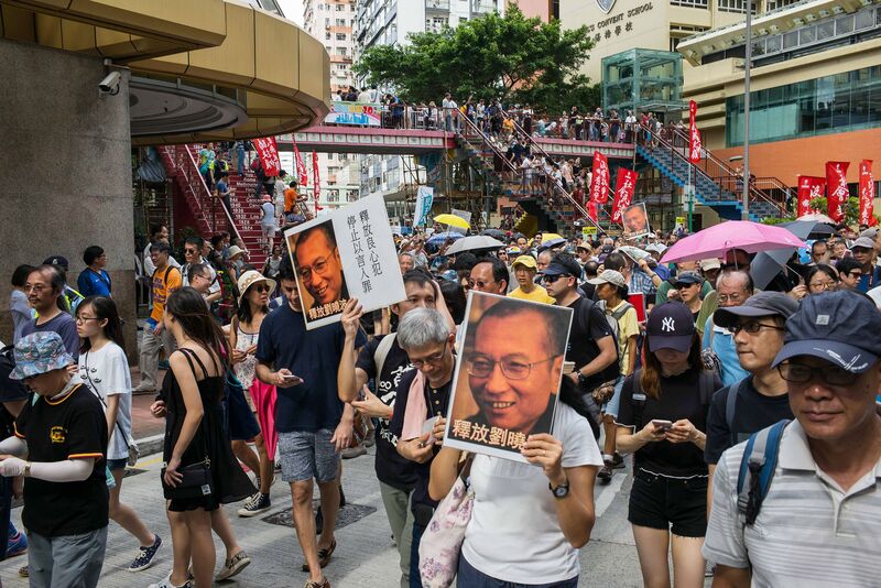 Protesters hold pictures of Liu Xiaobo, an activist, as they march during a demonstration in Hong Kong, China, on Saturday, July 1, 2017. President Xi Jinping warned a divided Hong Kong that challenges to China’s rule would not be tolerated and that the city’s leaders need to focus on finding new ways to profit from Chinese economic clout. Photographer: Billy H.C. Kwok/Bloomberg