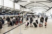 Travelers At Detroit Metro Airport As TSA Experiences Staff Shortages