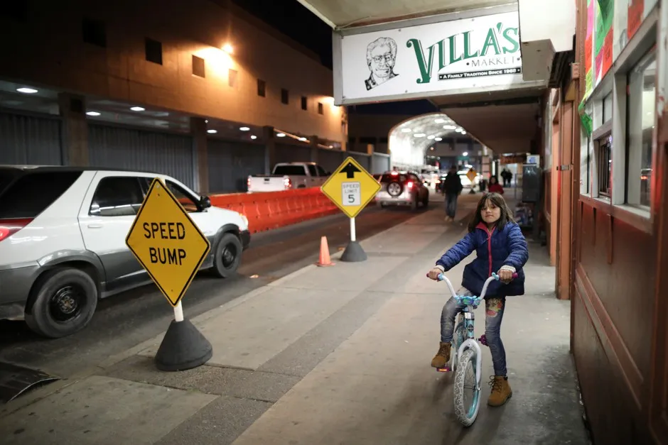 A girl rides her bicycle across the border from Mexico to the U.S. in Nogales.