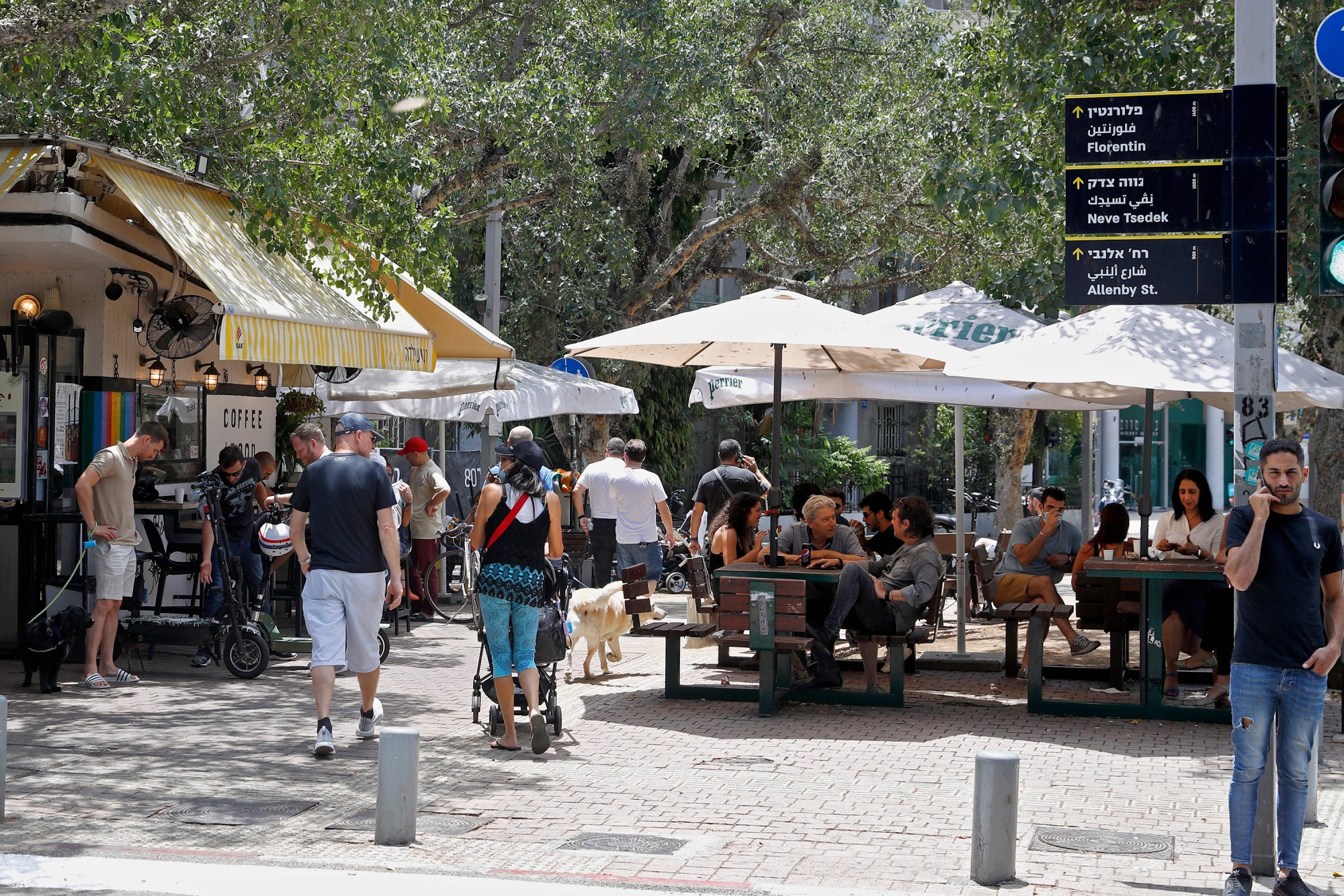 People sit outside a cafe in Tel Aviv.