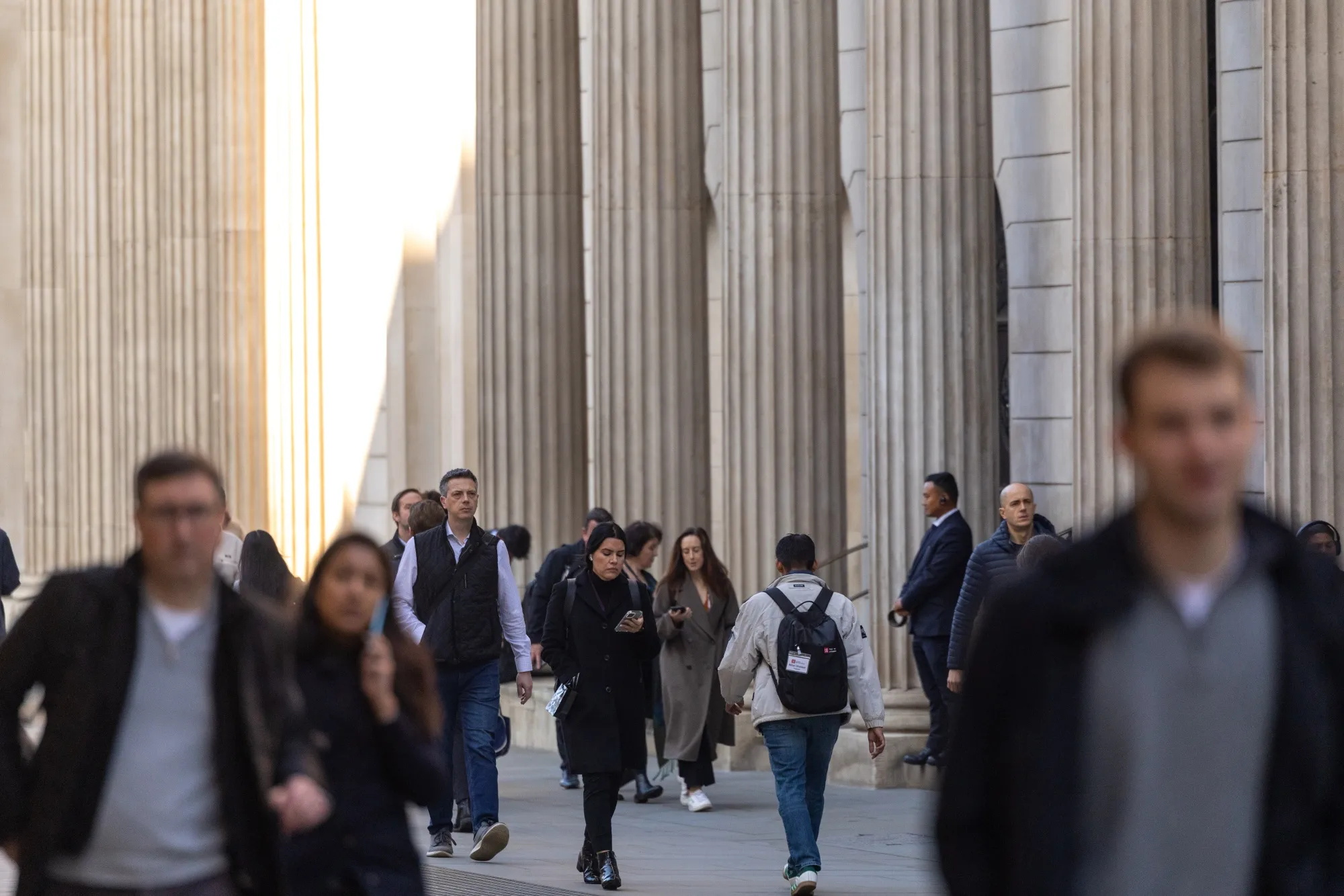 Commuters pass the Bank of England (BOE) in London.