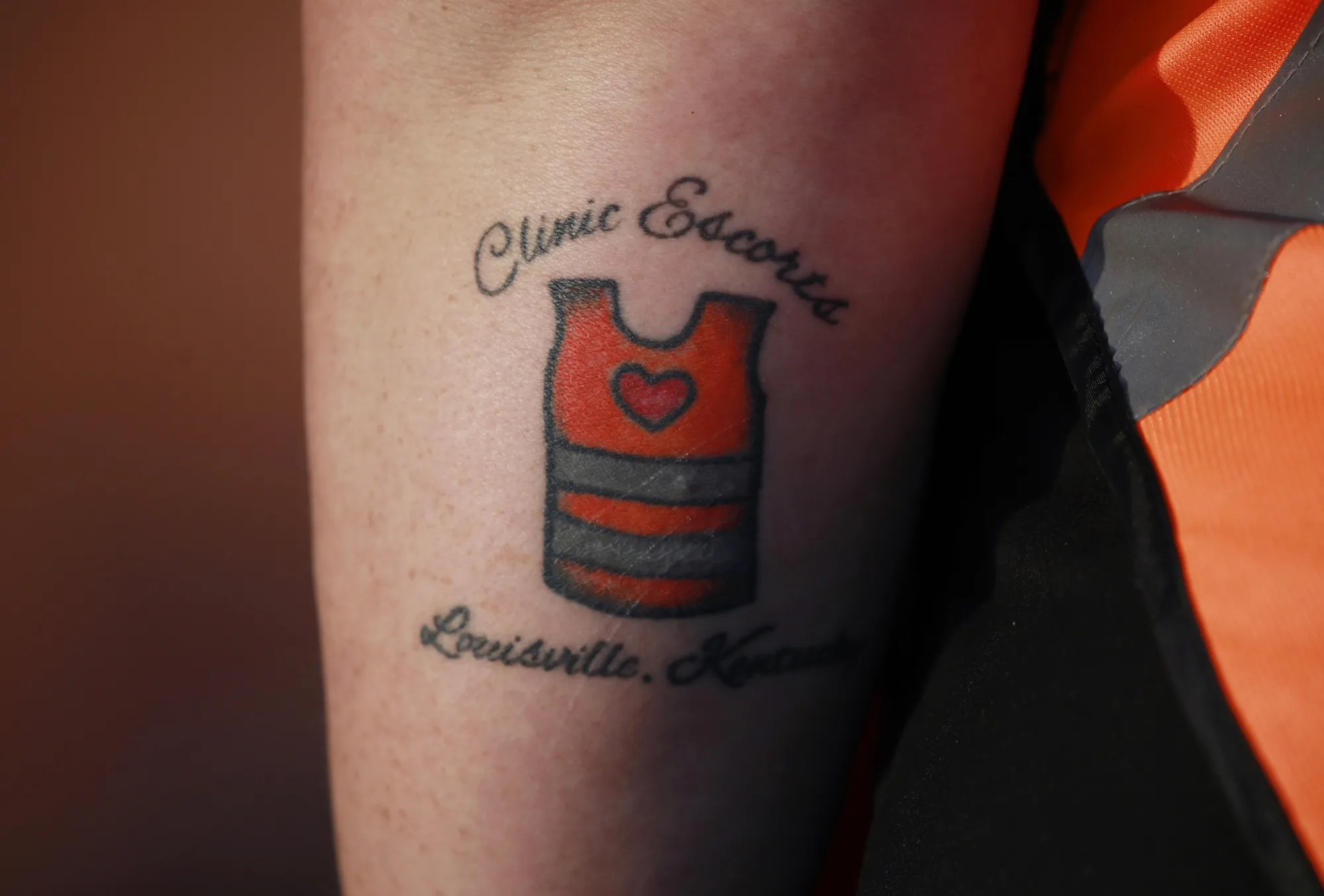 A volunteer with a "Clinic Escorts" tattoo outside the EMW Women's Surgical Center in Louisville, Kentucky.&nbsp;