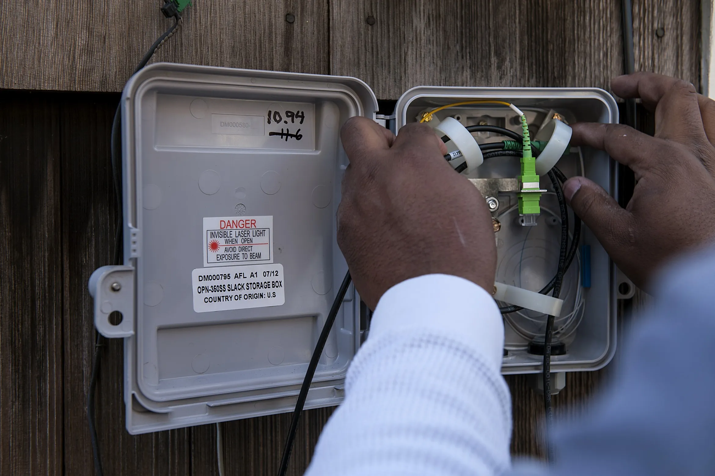 A technician installs Google Fiber network at the home in Kansas City, Kansas.