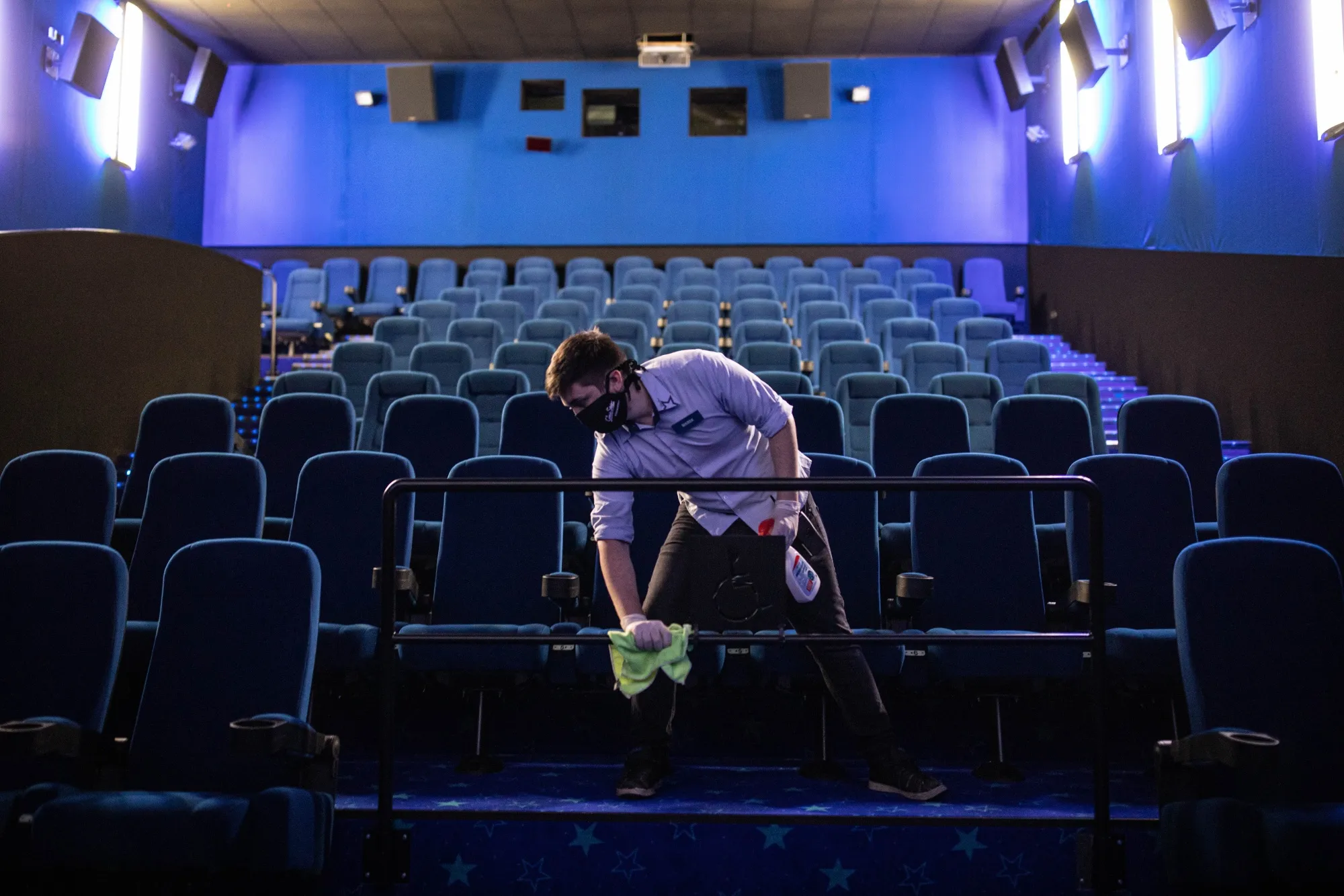 An employee sanitizes a railing at a CineStar s.r.o. cinema in Prague, Czech Republic on May 18, 2020.&nbsp;