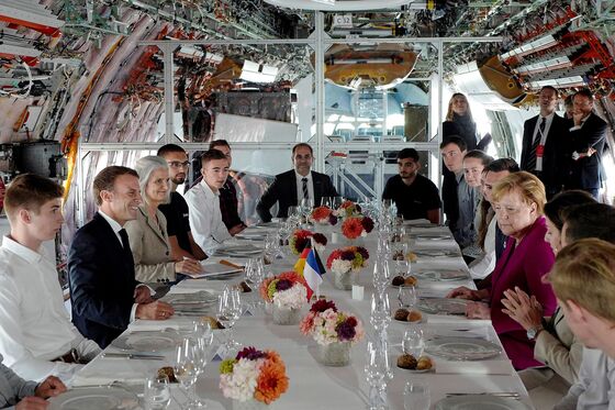 Macron, Merkel Make a Show of Unity With Tour of Airbus Factory