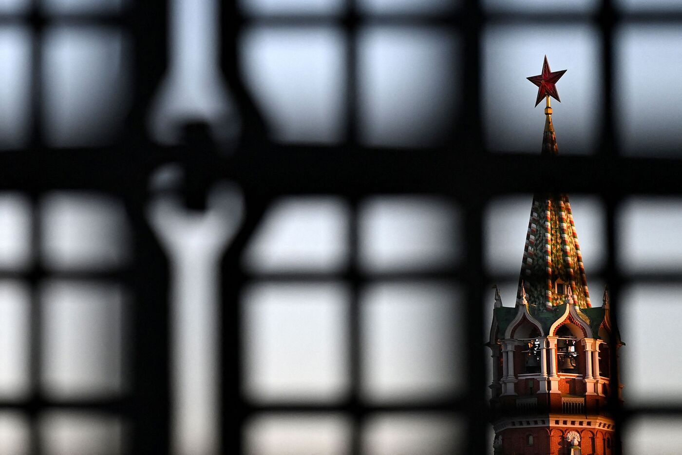 The Kremlin's Spasskaya tower is seen through part of a lattice of the Nikolsky Gate in central Moscow.