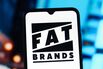In this photo illustration, the FAT Brands logo is seen