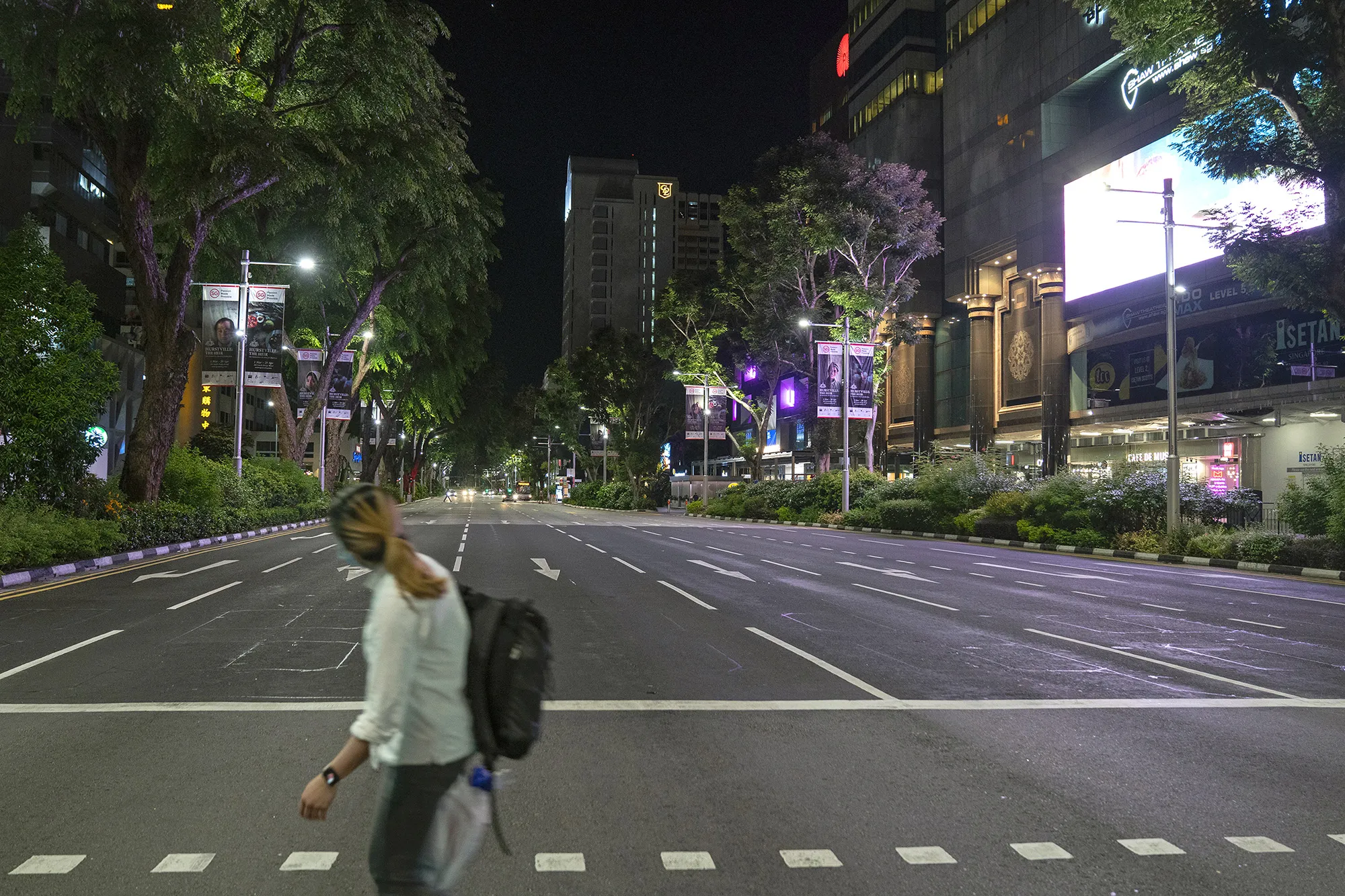 A pedestrian crosses Orchard Road during a partial lockdown imposed due to the coronavirus in Singapore, on&nbsp;April 20.